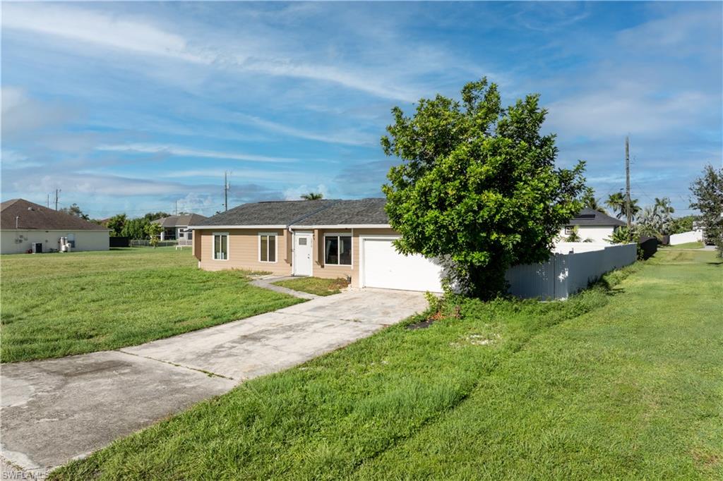 Single story home with concrete driveway and a garage