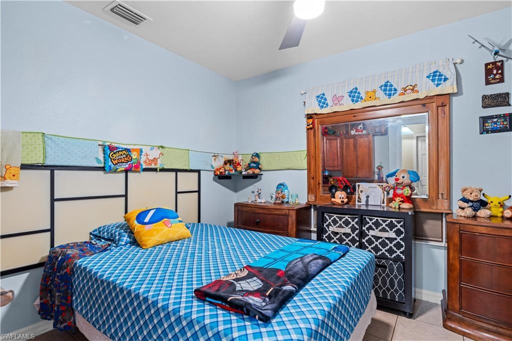 Bedroom with tile patterned flooring and ceiling fan