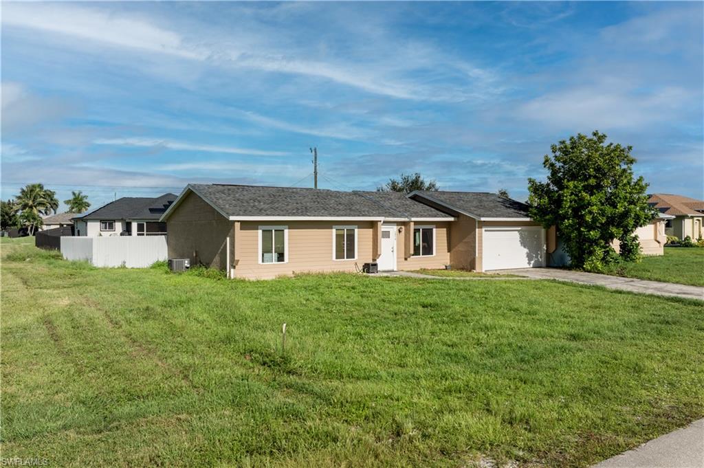Single story home with a garage and concrete driveway