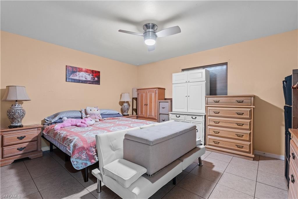 Bedroom featuring light tile patterned floors and ceiling fan