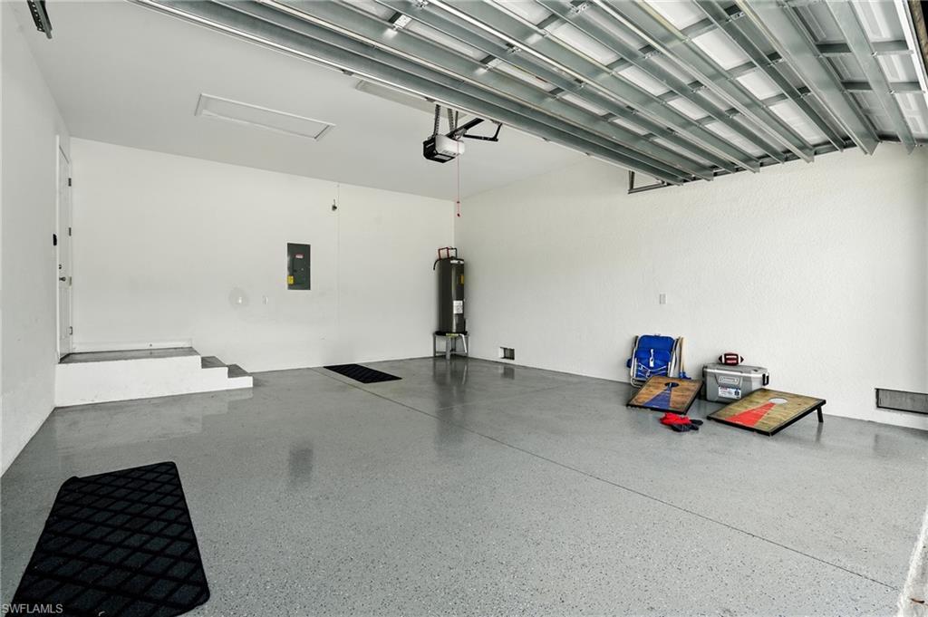 Garage featuring electric panel and water heater