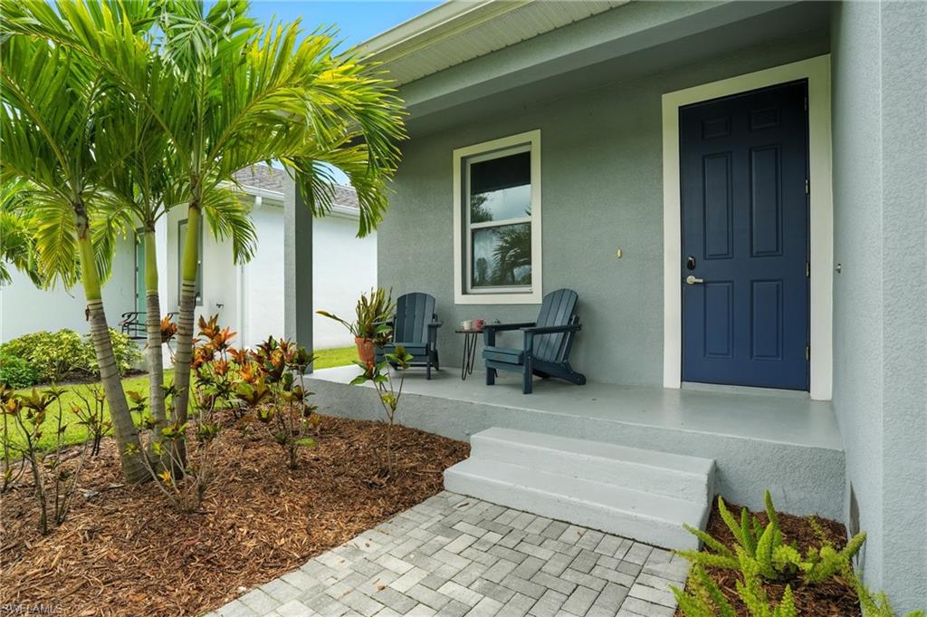 Property entrance with stucco siding and covered porch
