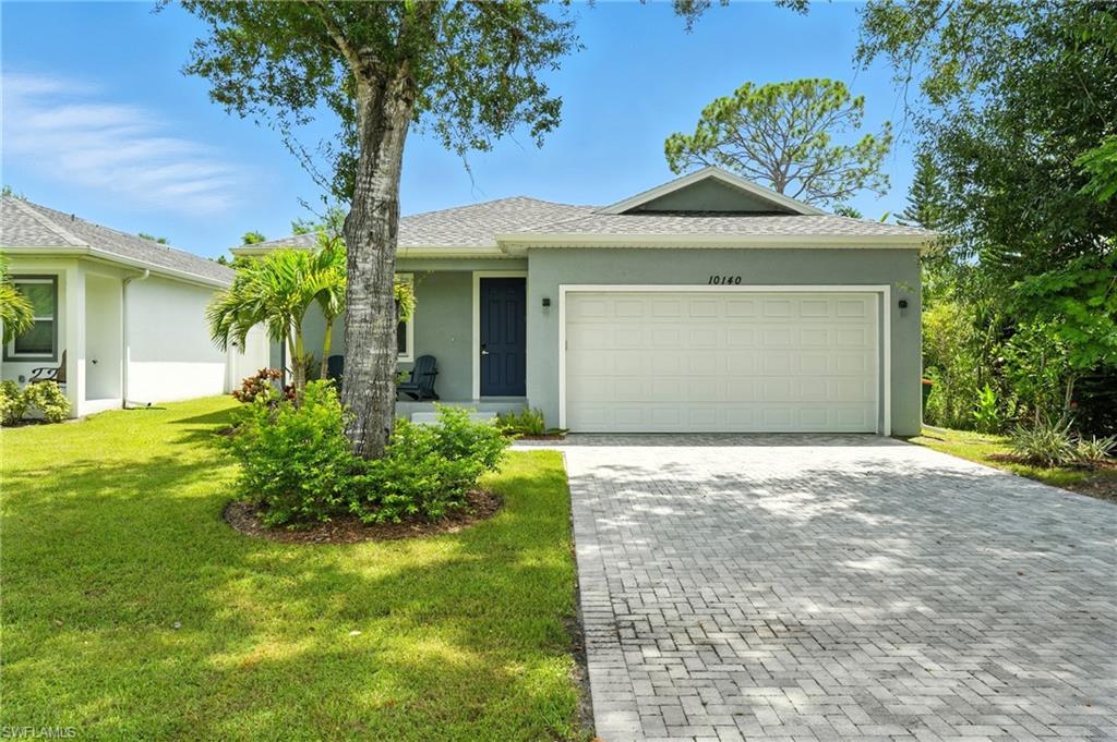 Single story home featuring decorative driveway, stucco siding, a front lawn, roof with shingles, and an attached garage