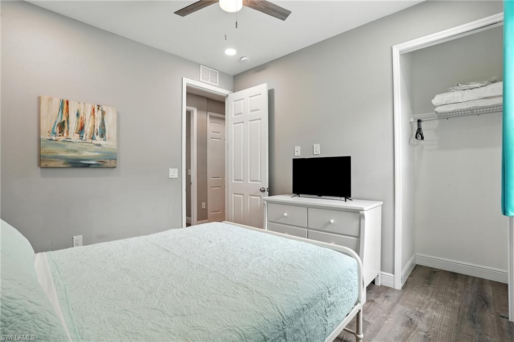 Bedroom featuring wood finished floors, a closet, and a ceiling fan