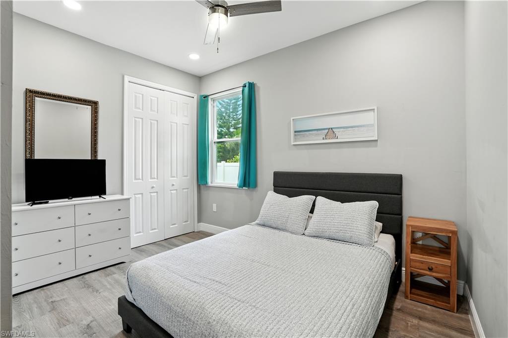 Bedroom with light wood-style floors, a ceiling fan, a closet, and recessed lighting