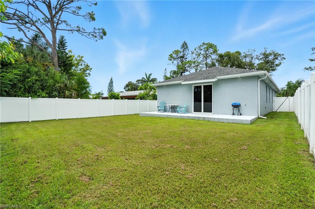 Back of property with a fenced backyard, a patio area, stucco siding, and a shingled roof