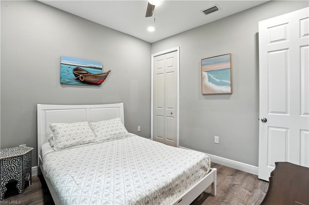 Bedroom featuring wood finished floors, ceiling fan, a closet, and recessed lighting