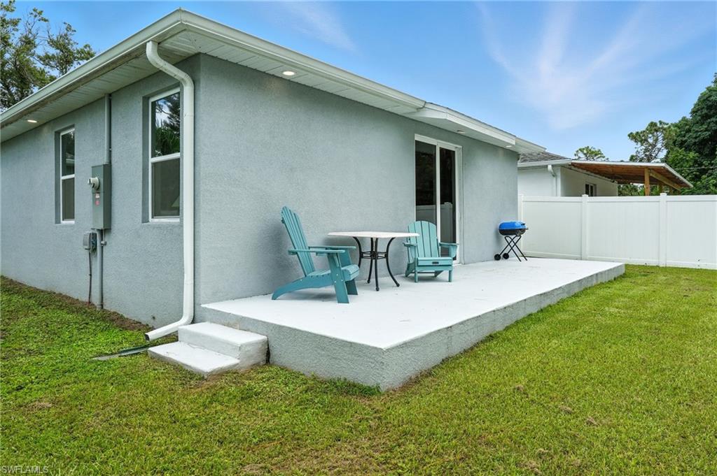 Rear view of house featuring stucco siding and a patio