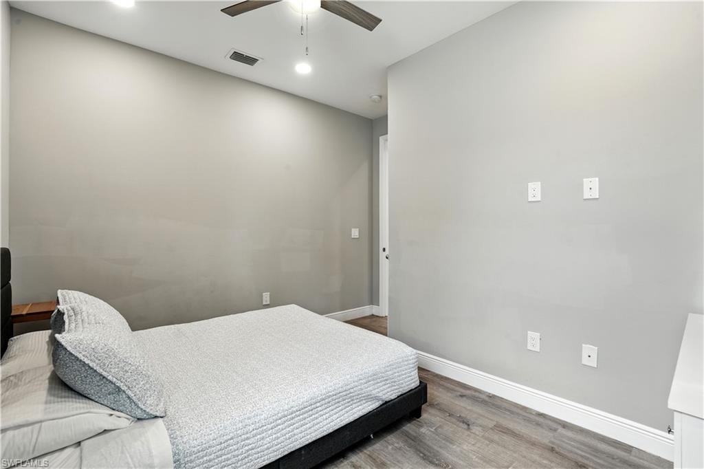 Bedroom featuring wood finished floors, ceiling fan, and recessed lighting