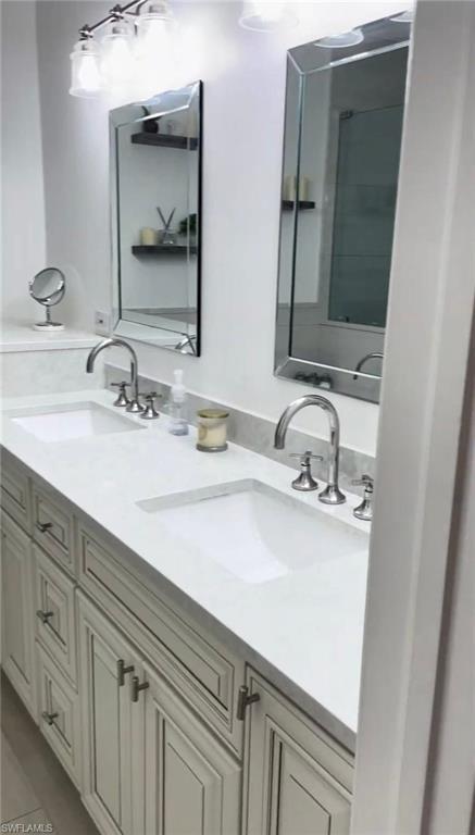 Bathroom featuring double vanity and light tile patterned flooring