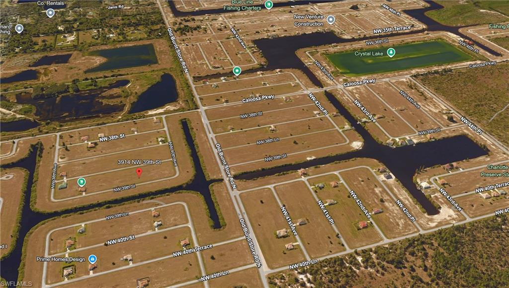 Aerial view of property's location featuring a large body of water and nearby suburban area