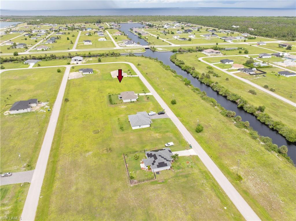 Aerial perspective of suburban area featuring a large body of water