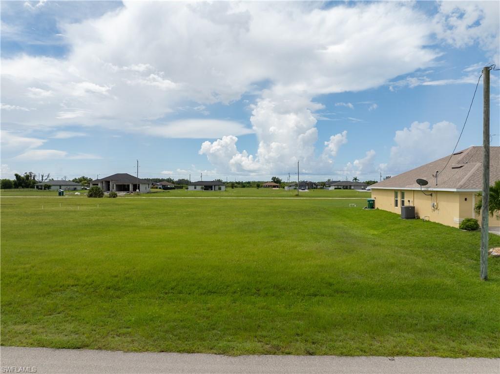 View of home's community with a yard
