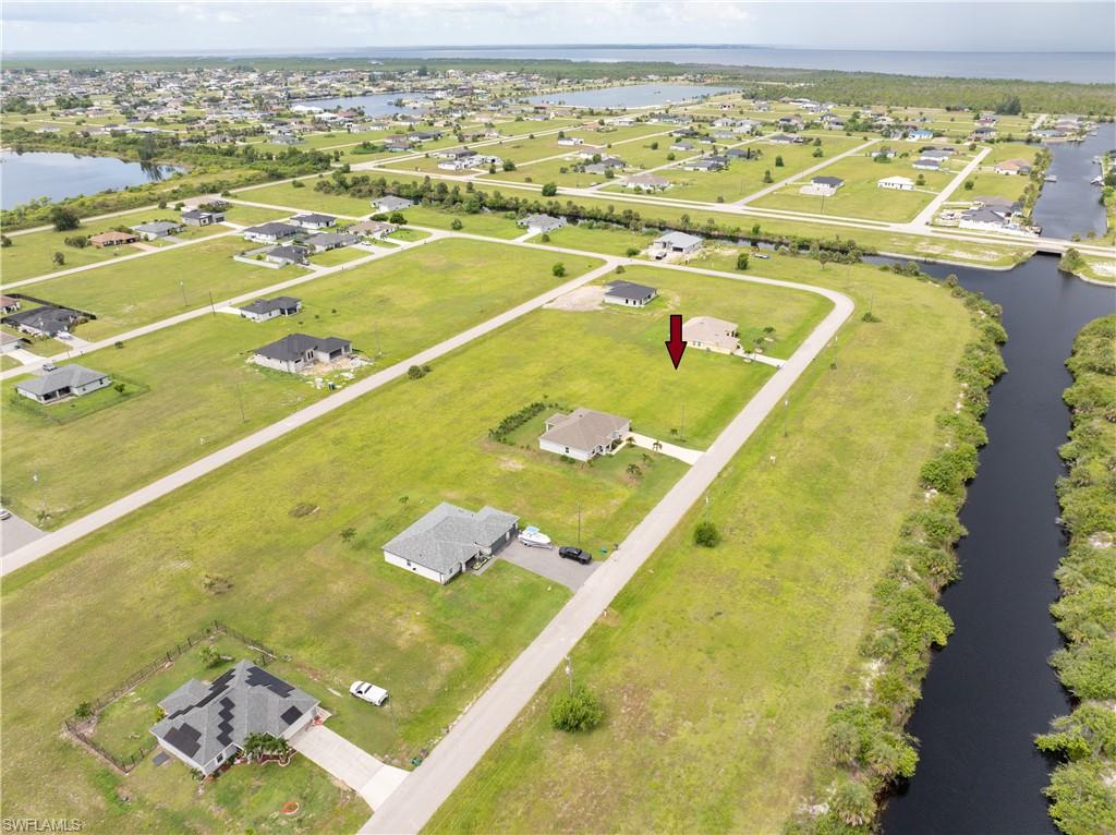 Aerial perspective of suburban area with a nearby body of water