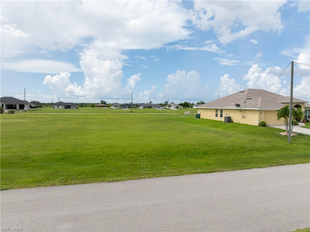 View of property's community with a yard
