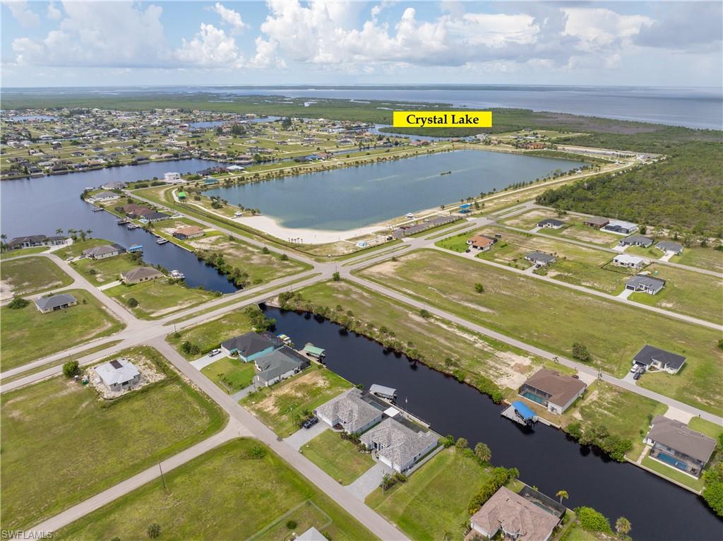 Aerial overview of property's location featuring a large body of water and nearby suburban area