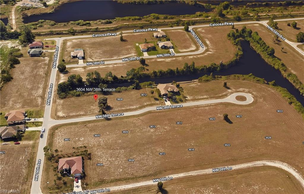 View of property location featuring a nearby body of water and nearby suburban area