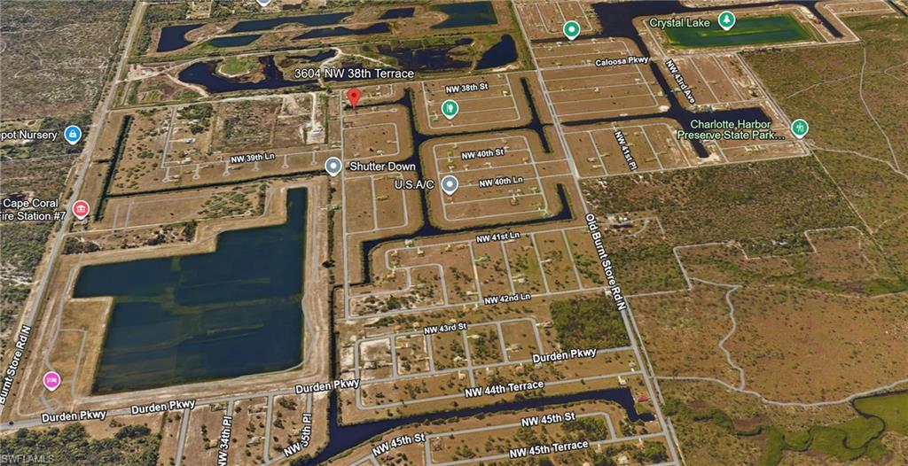 Aerial view of residential area featuring a nearby body of water