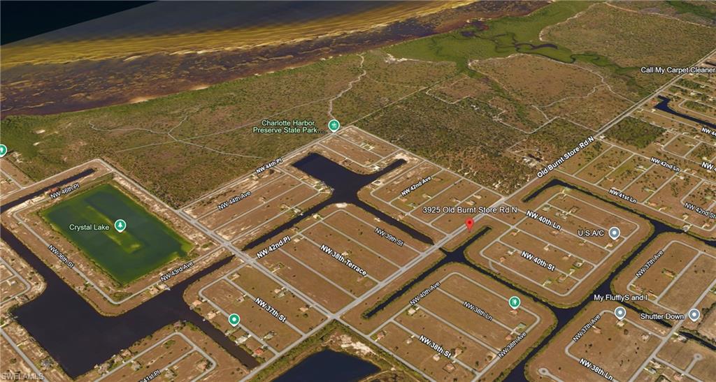Aerial perspective of suburban area featuring a large body of water
