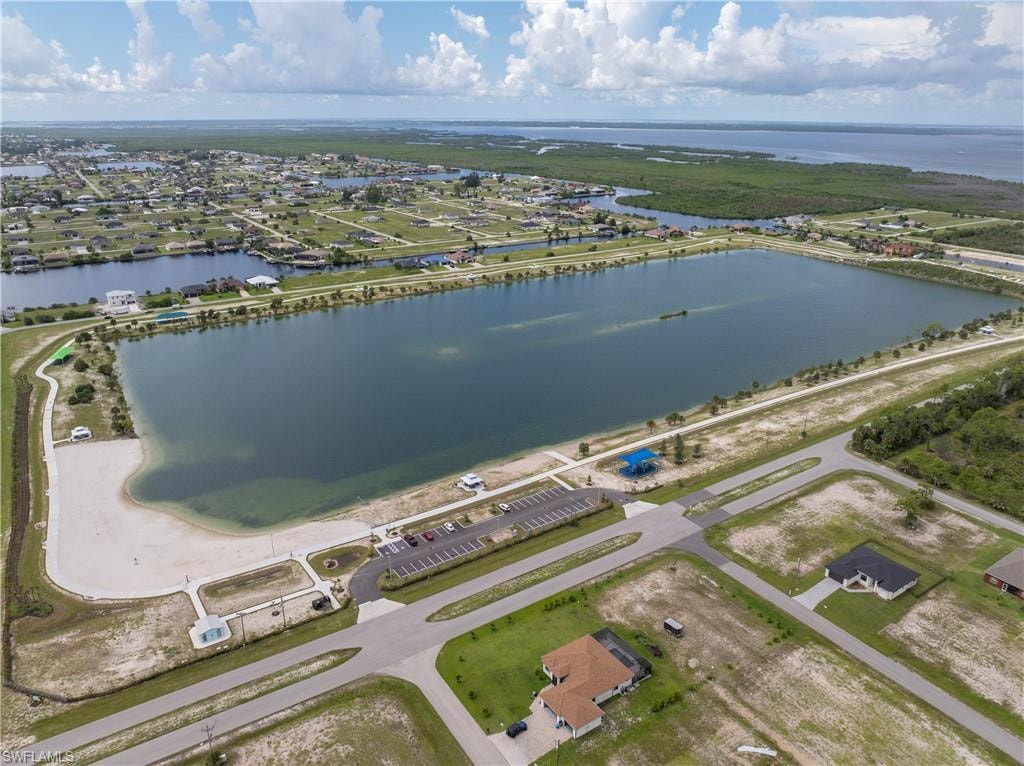 Aerial view of residential area featuring a nearby body of water