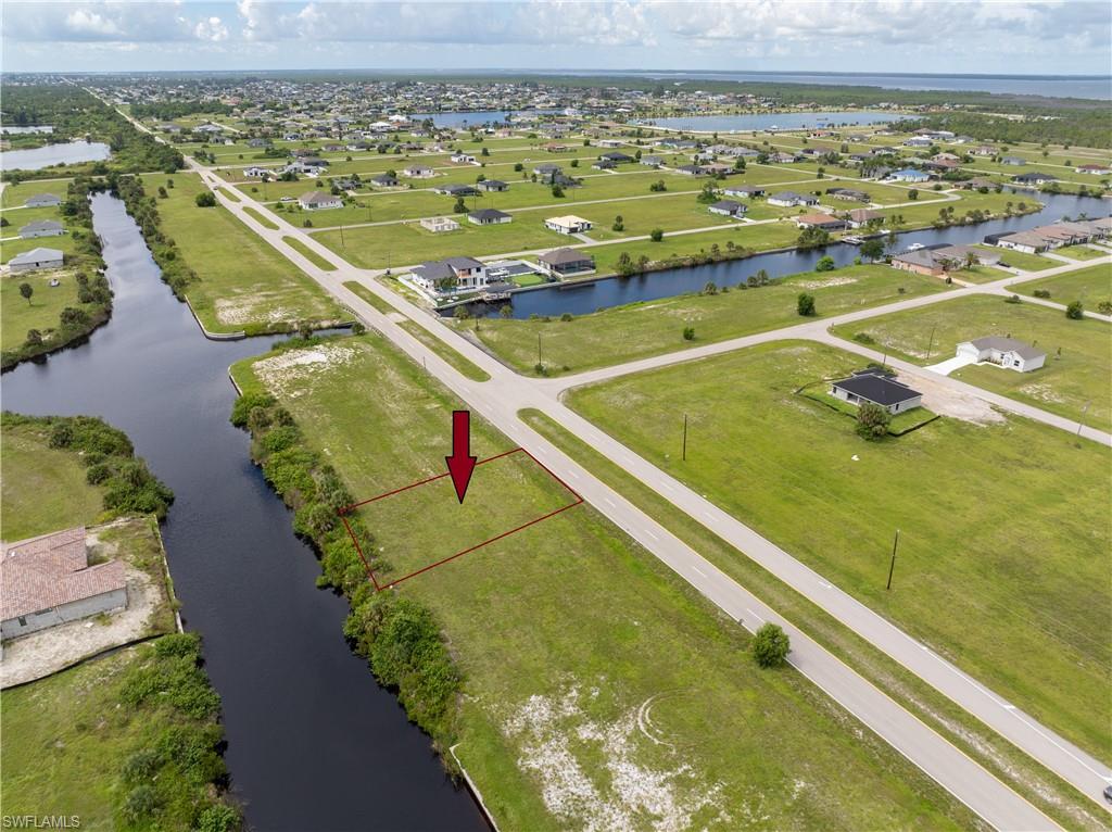 Aerial perspective of suburban area with a nearby body of water