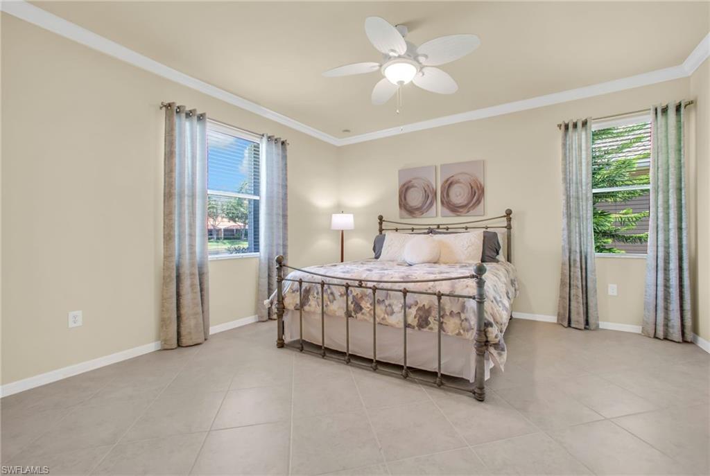 Bedroom featuring crown molding, ceiling fan and natural light