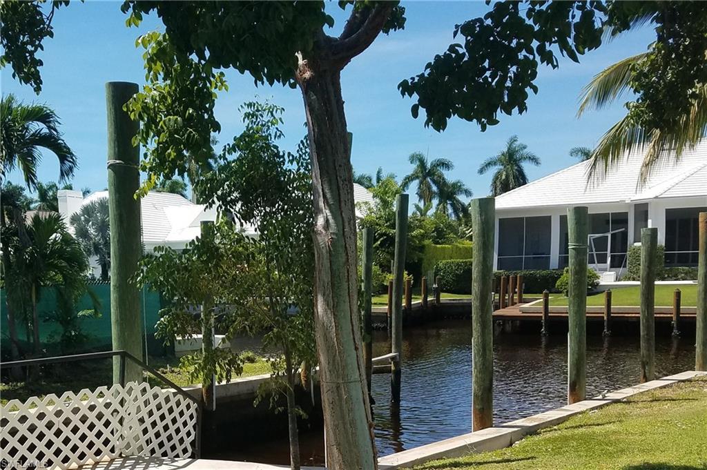 Dock area with a water view and a sunroom