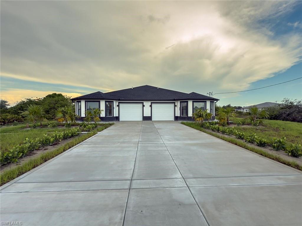 Single story home featuring an attached garage and driveway