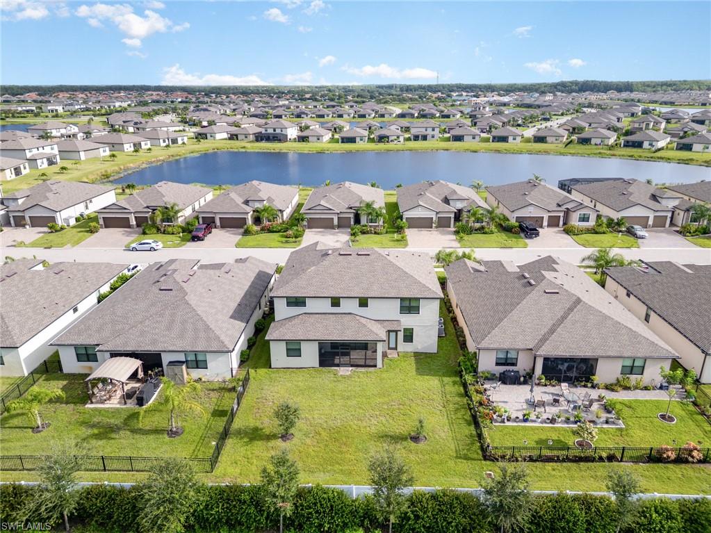 Aerial view of residential area featuring a nearby body of water