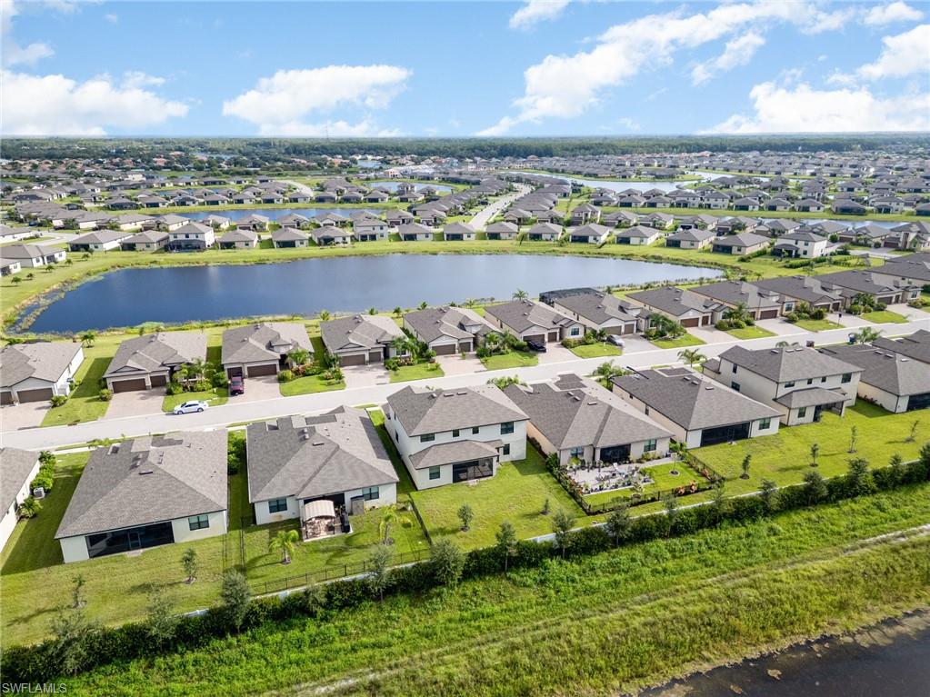 Aerial perspective of suburban area with a nearby body of water