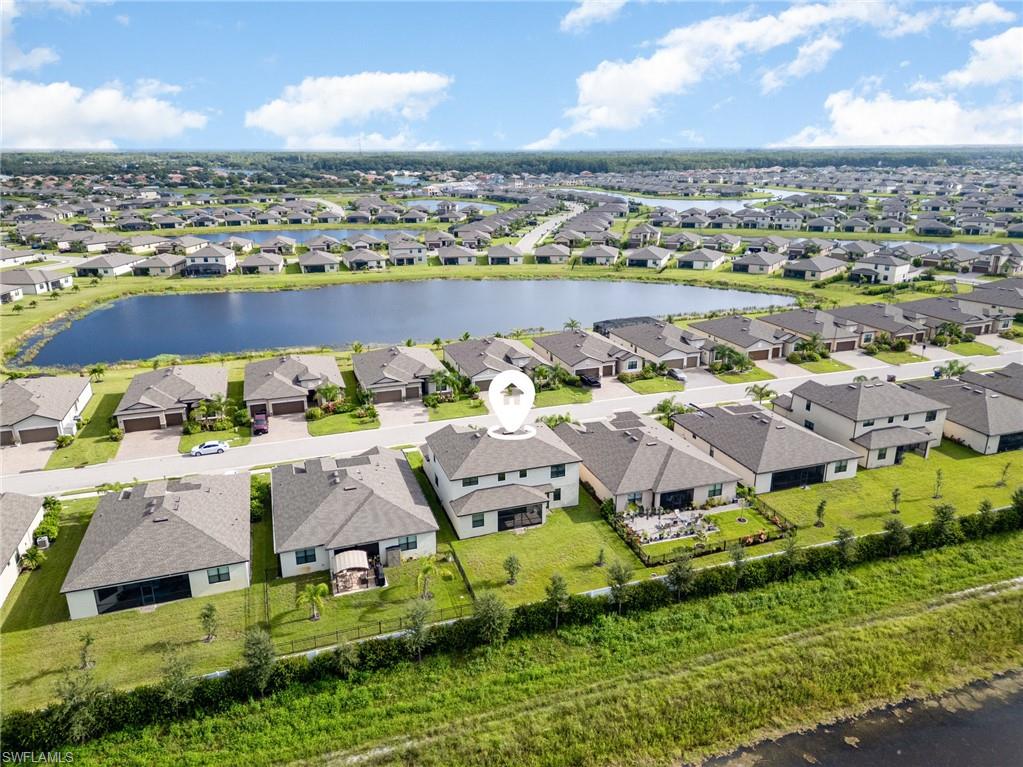 Aerial perspective of suburban area with a nearby body of water