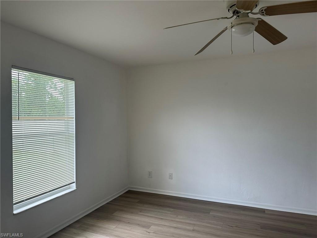 Spare room featuring light wood-style floors and a ceiling fan