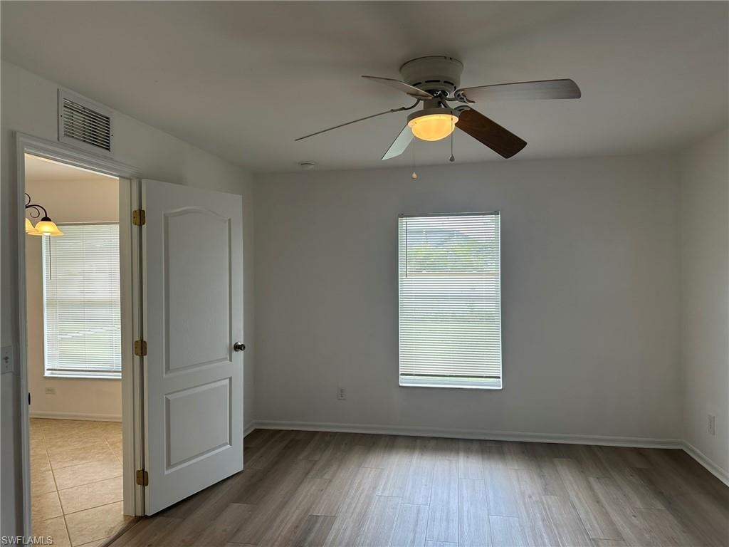 Unfurnished room featuring light wood-type flooring and ceiling fan