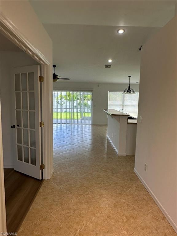 Hallway with recessed lighting and light tile patterned floors