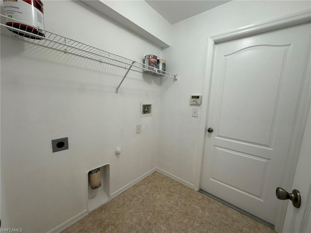 Laundry room featuring light tile patterned flooring, hookup for a washing machine, and electric dryer hookup