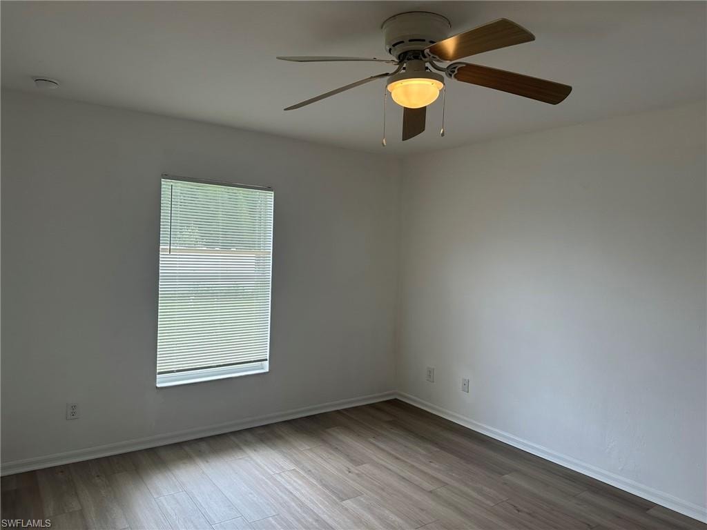 Spare room featuring light wood-style flooring and a ceiling fan