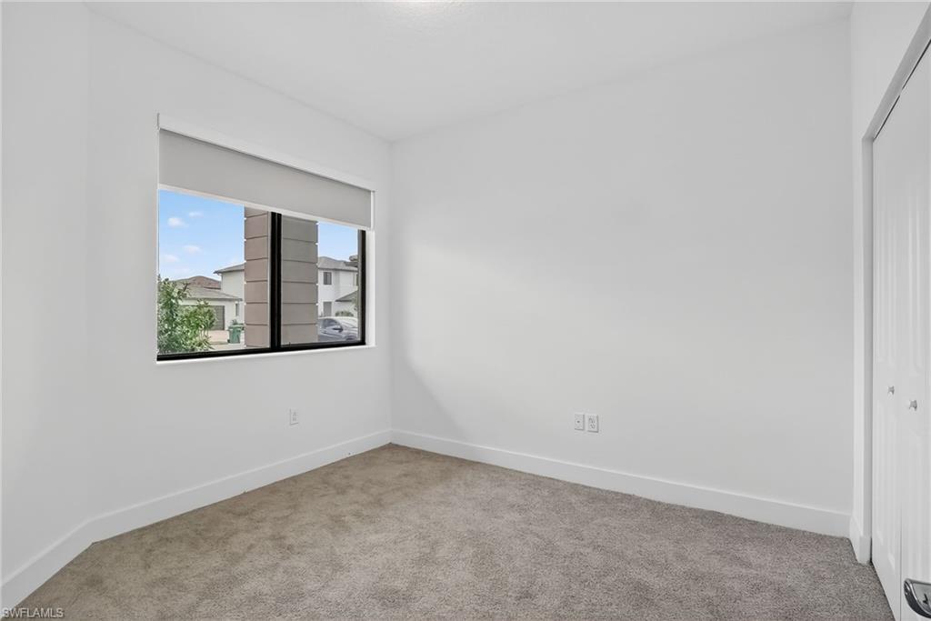 Unfurnished room with carpet floors and baseboards