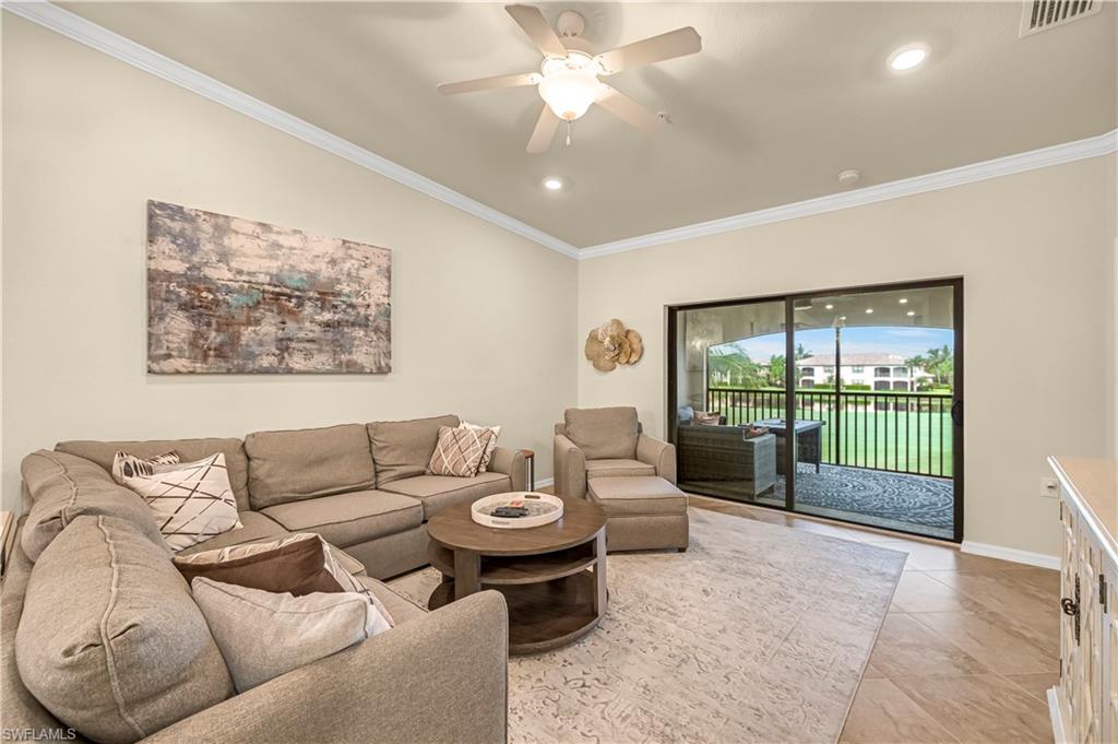 Living area featuring crown molding, recessed lighting, a ceiling fan, vaulted ceiling, and light tile patterned flooring