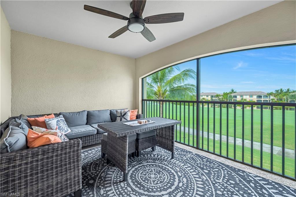 Lanai with TV and golf course view featuring a water view