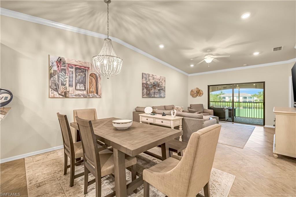 Dining space featuring ornamental molding, recessed lighting, a chandelier, a ceiling fan, and light tile patterned floors