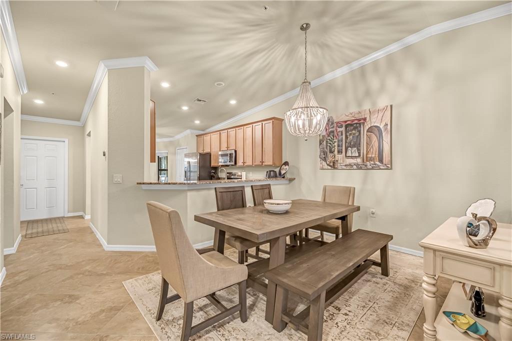Dining space with recessed lighting, crown molding, and a chandelier