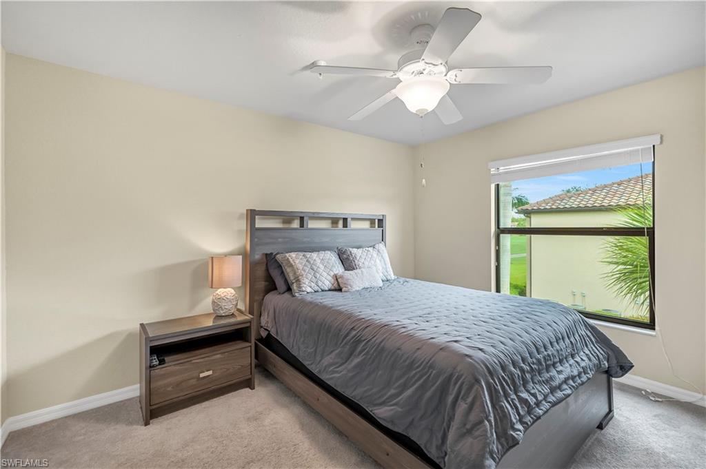 Carpeted bedroom featuring baseboards and a ceiling fan