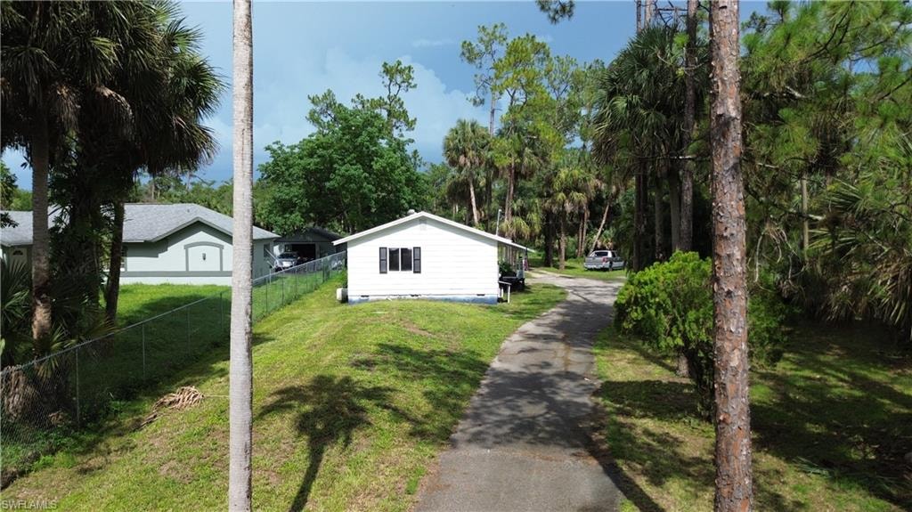 View of yard with asphalt driveway
