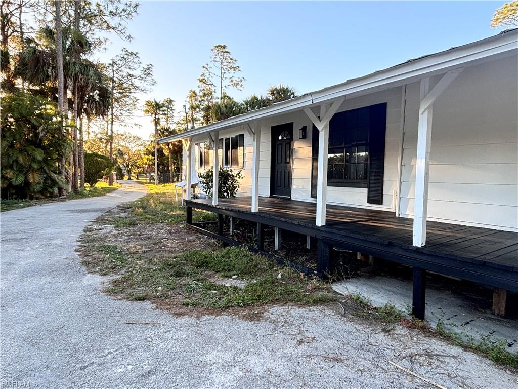 View of side of home with covered porch