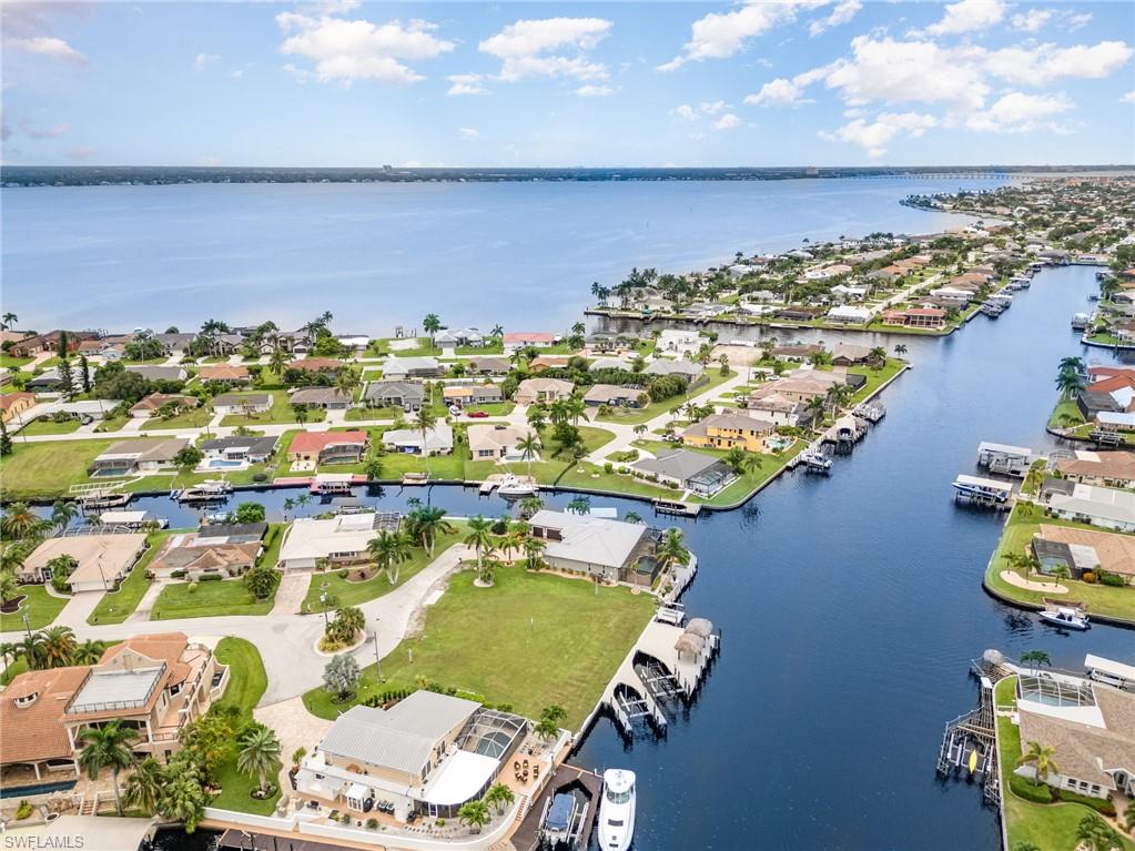Aerial view of residential area featuring a large body of water