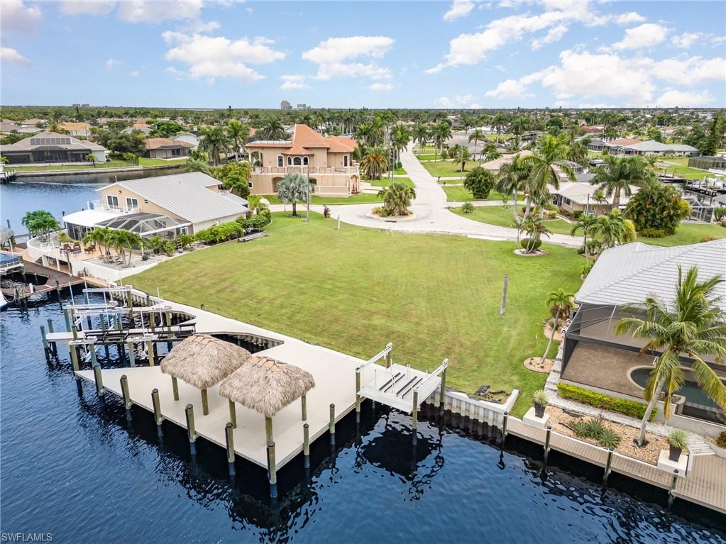 Dock area with a water view, a residential view, and boat lift
