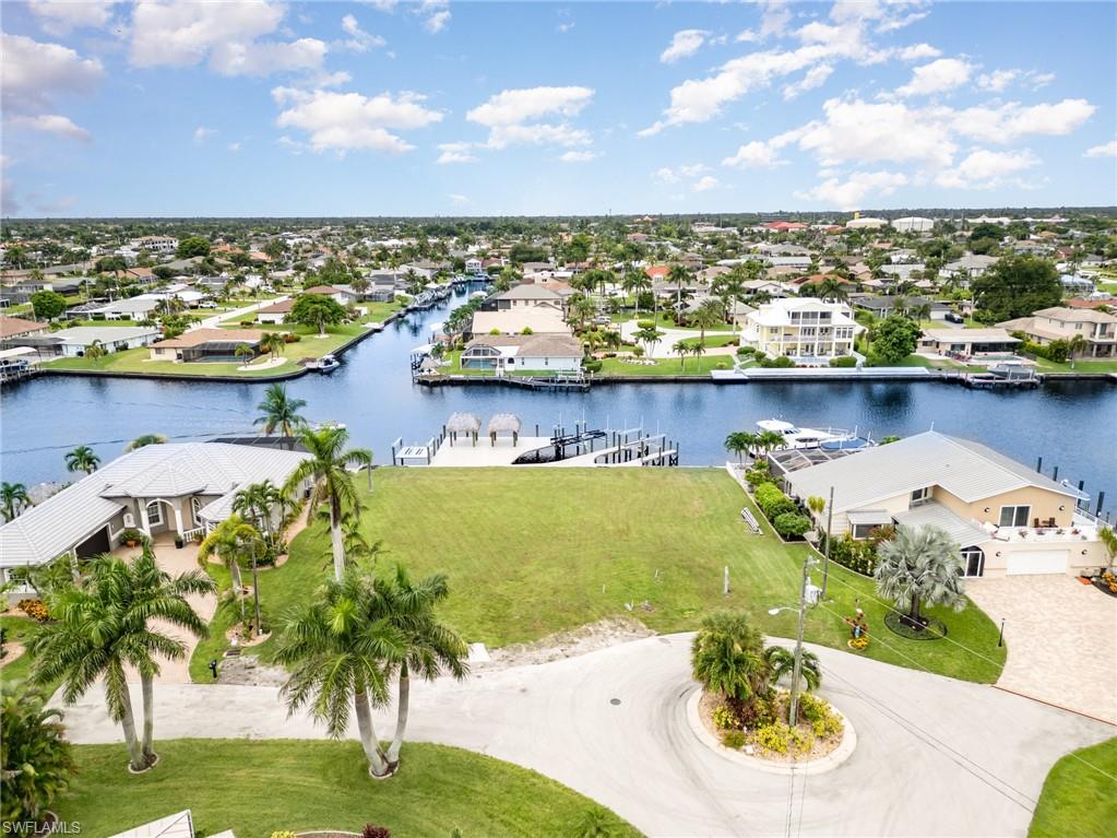 Aerial perspective of suburban area featuring a large body of water