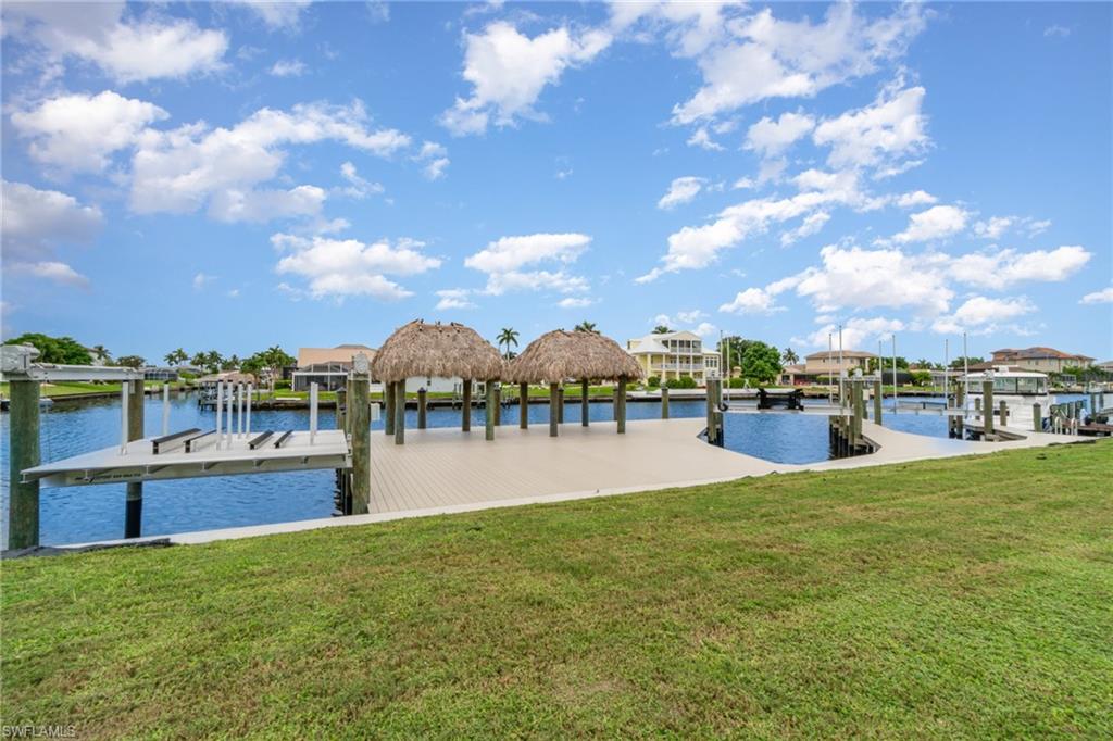 Dock featuring a yard, a water view, and a residential view
