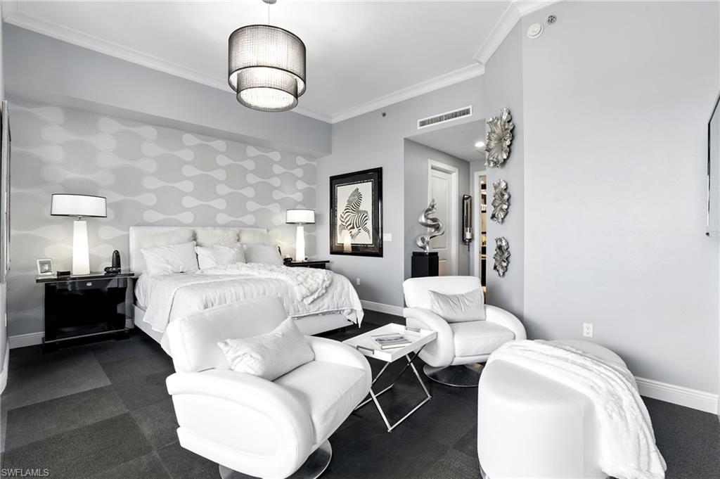 Bedroom with ornamental molding, wallpapered walls, and an accent wall - Virtually Edited Image