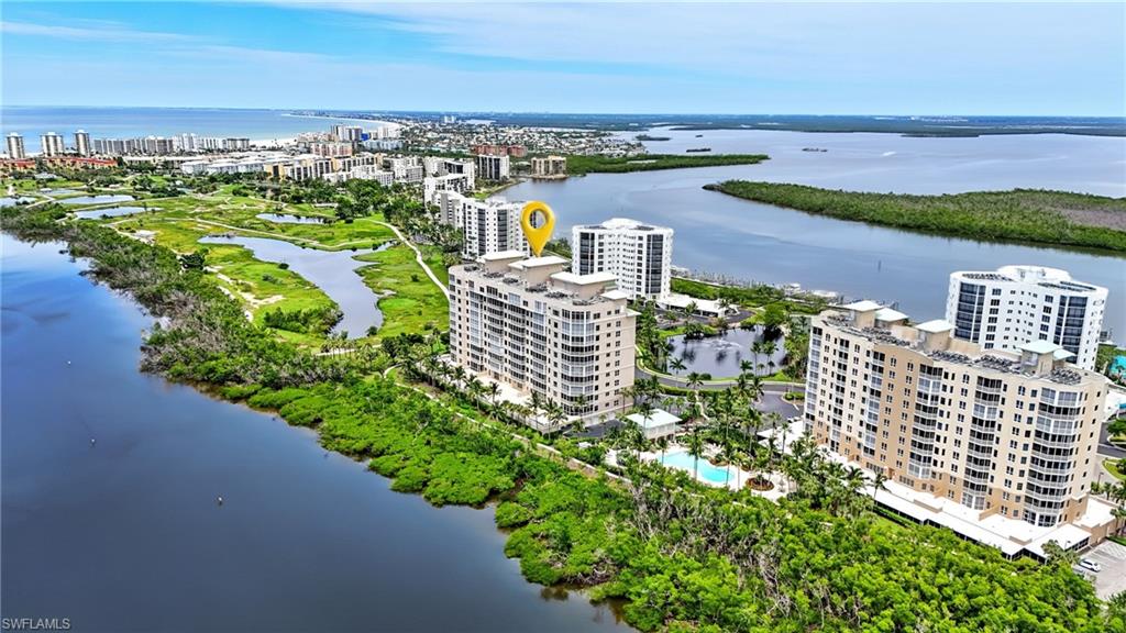 View of urban area with apartment complex / building and a large body of water - Virtually Edited Image